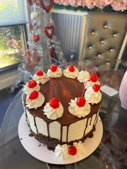 Chocolate drip cake with whipped cream and cherries