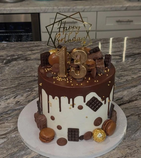 Thirteenth birthday cake with chocolate drip, gold numbers and chocolate bars