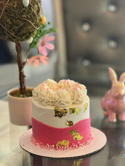 Small pink and white cake with a bunny decoration