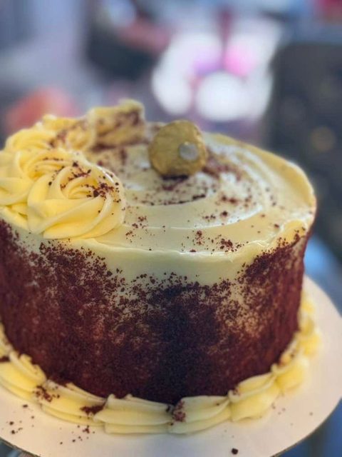 Tres leches cake with cream and a dusting of cocoa
