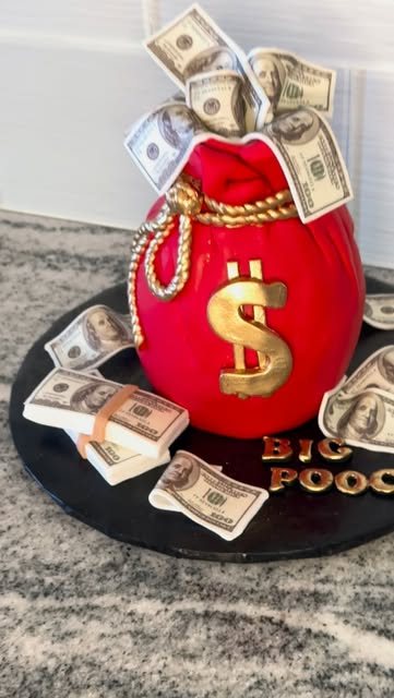 Red money-bag cake with a gold dollar sign